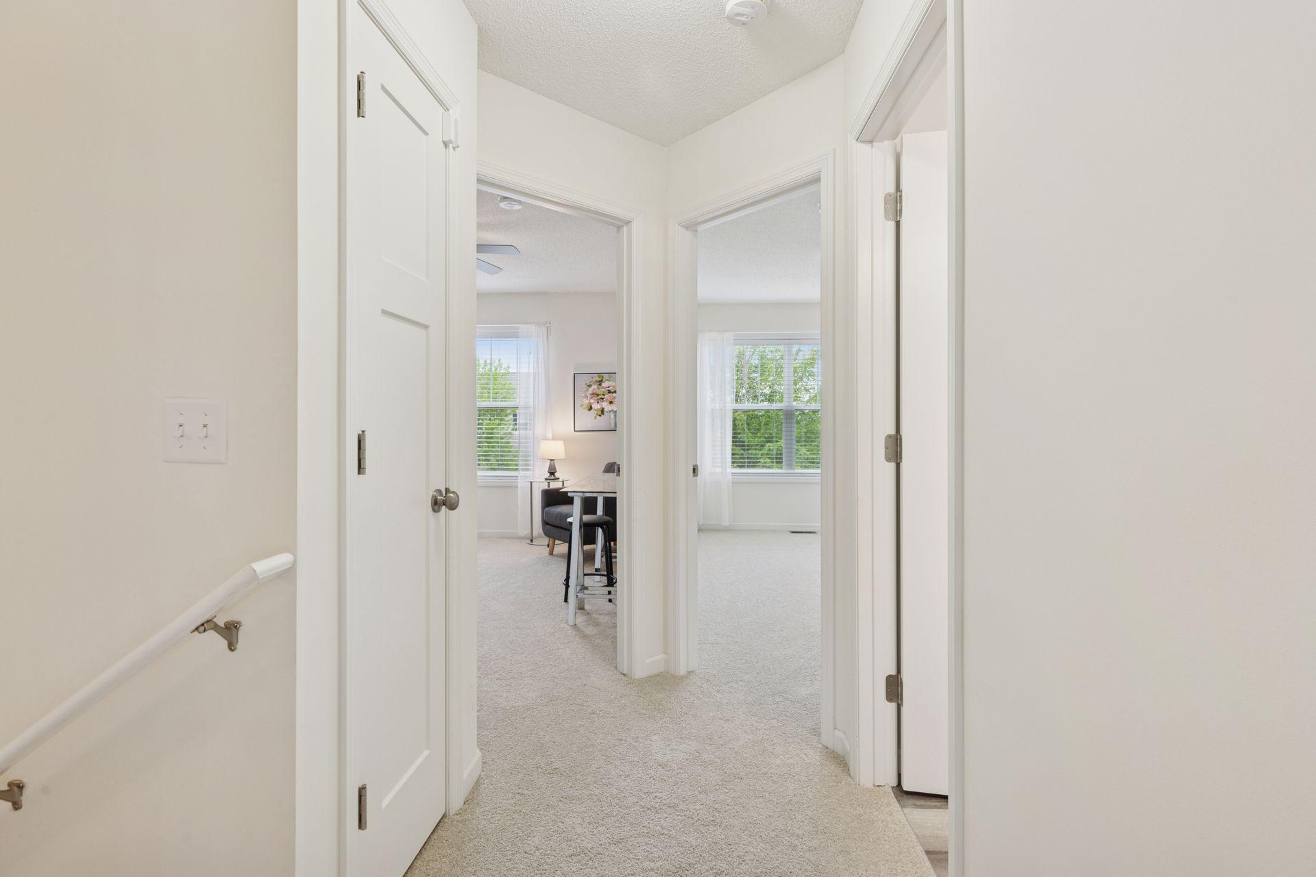 Upper level hallway features new carpet and paint.