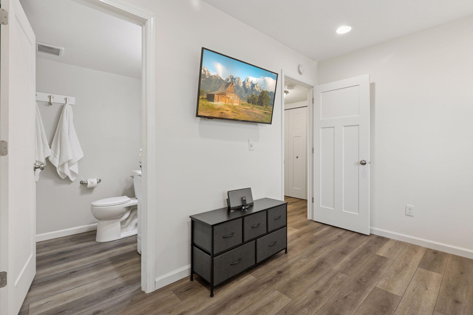 LL 4th Bedroom or family room with attached 3/4 bathroom. Features LVP flooring and fresh paint. Added in 2020.
