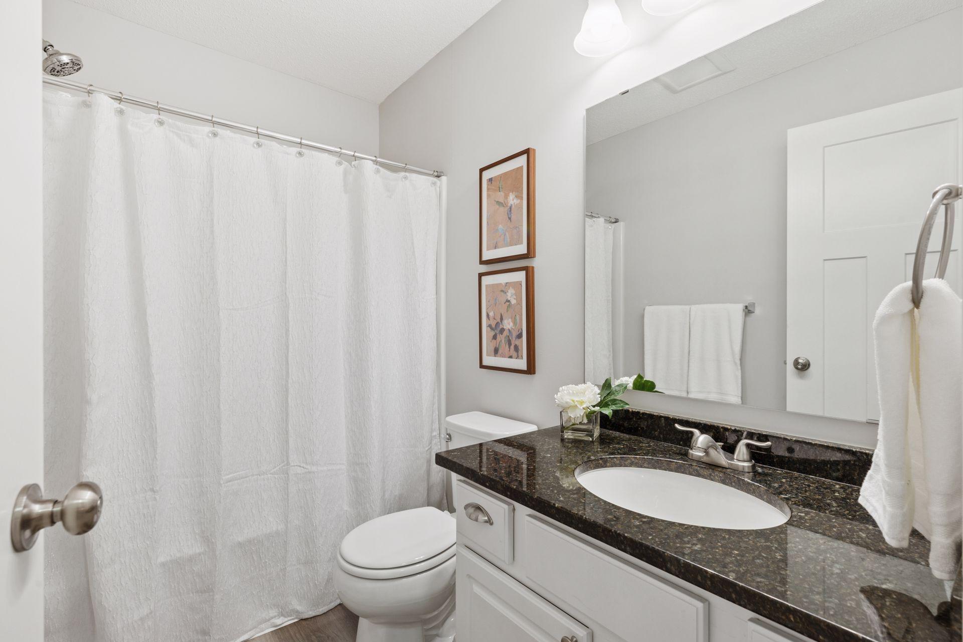 Upper level full guest bathroom. Fresh paint, granite counter top and LVP flooring