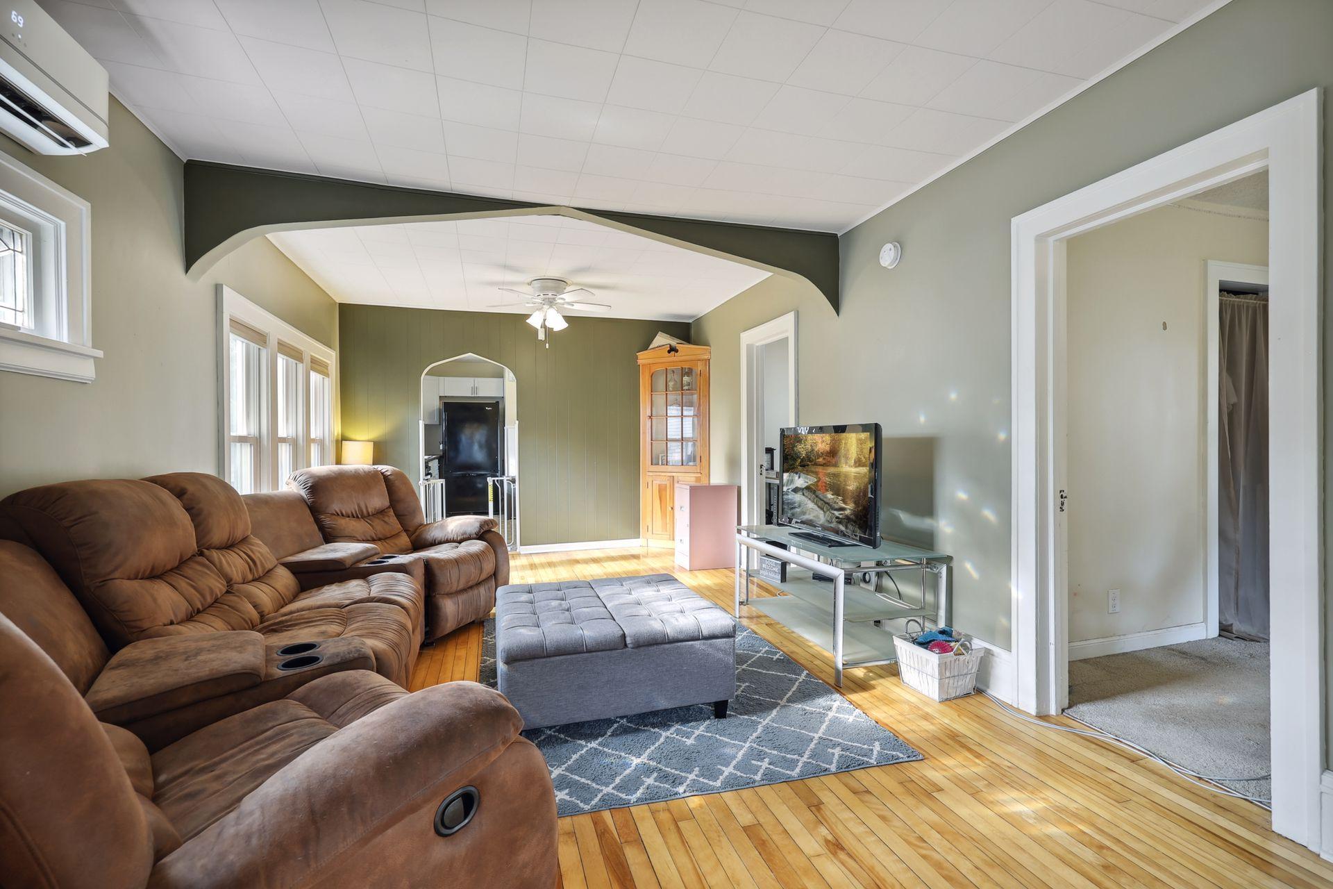 Stylish coved ceiling accents and lovely mix of natural floors and white trim.