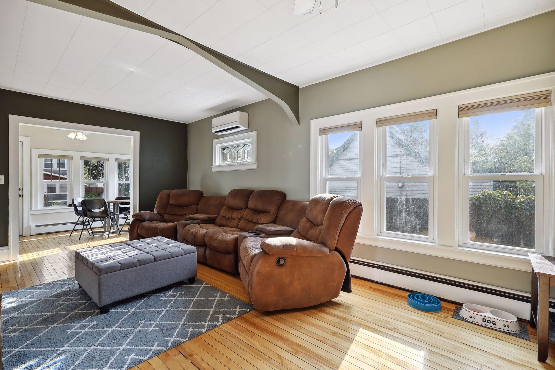 Fabulous living room area w/ large windows and gleaming hardwood floors.