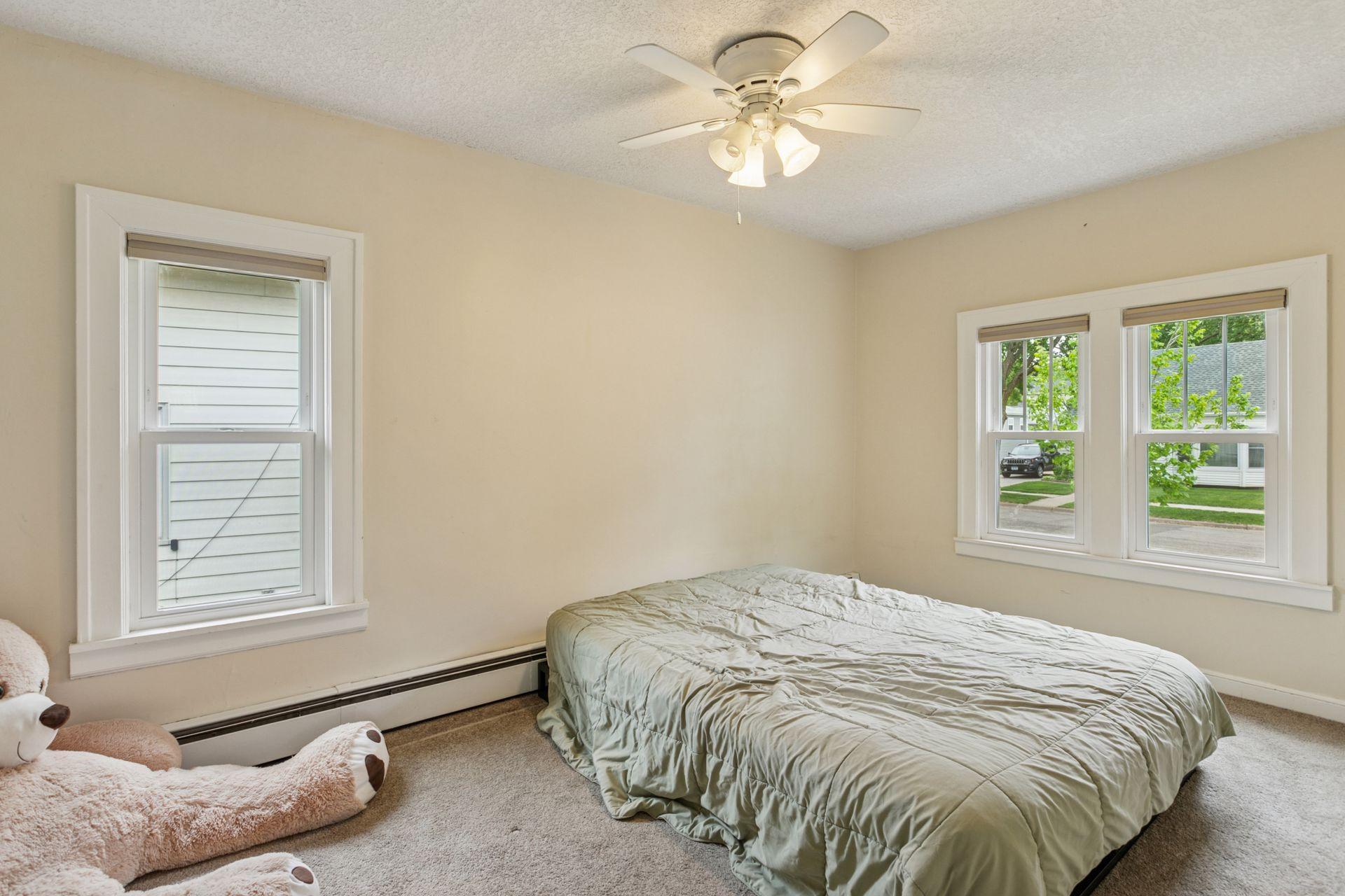 Main level bedroom w/ double windows.