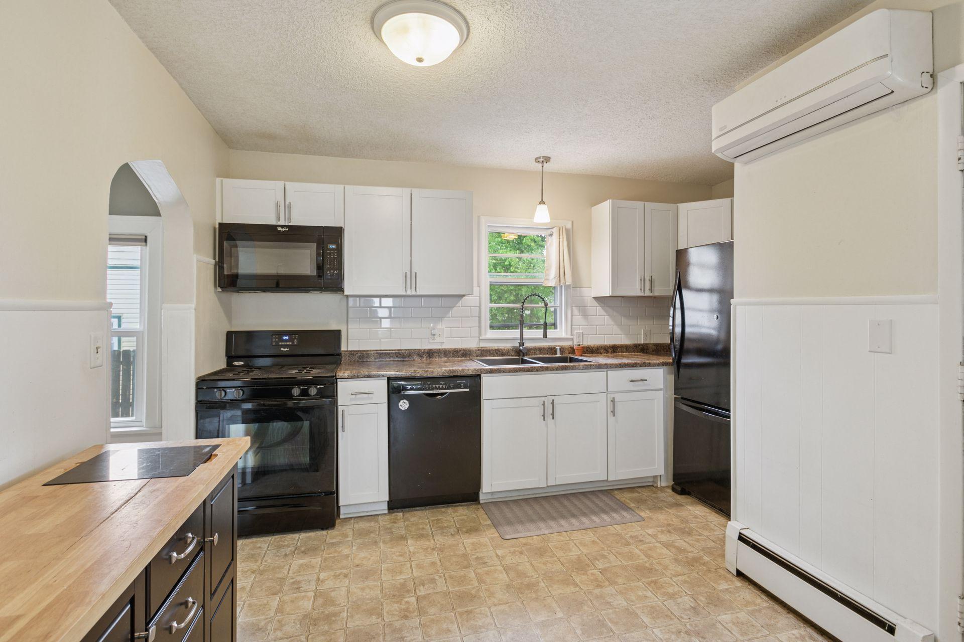 Abundance of cabinetry in kitchen and recently installed, Subway tiled backsplash.