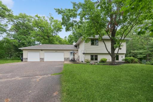 Three-Car Garage â Attached garage with tall doors and room to spare.