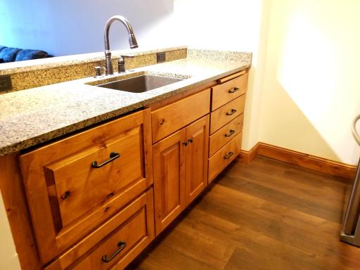 Pull out dishwasher and custom knotty alder cabinets. Granite counters, back splash and wine bar.