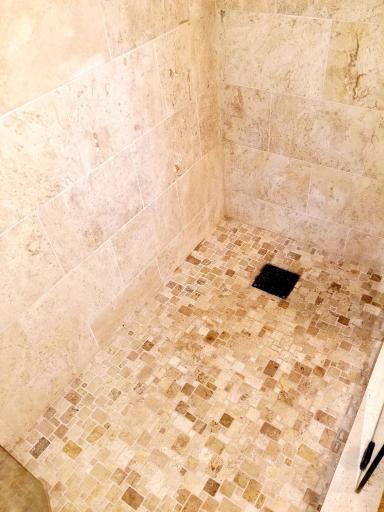 One of a kind custom tile floor and drain in the shower.