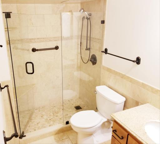 Custom tile bath with heated travertine flooring. Walk in shower.