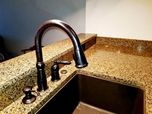 Retractable faucet and sprayer, large sink with a garbage disposal.
