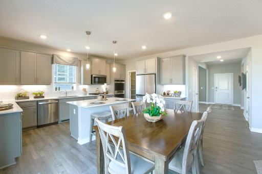 Open floor plan with huge walk in pantry, plus informal and formal dining area. *Photos of a similar home. Colors and options may vary.
