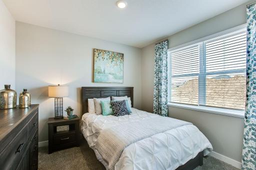 Main level bedroom perfect as a full time bedroom, guest bedroom or an office. *Photos of a similar home. Colors and options may vary.