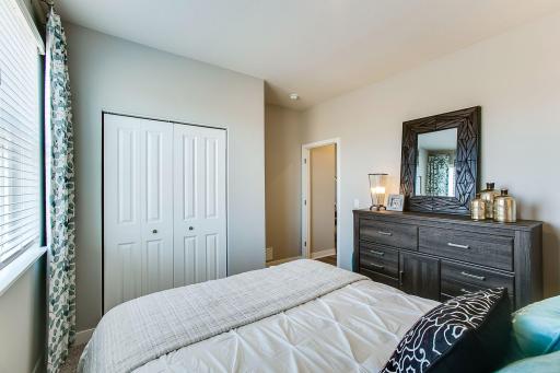 Main level bedroom perfect as a full time bedroom, guest bedroom or an office. *Photos of a similar home. Colors and options may vary.