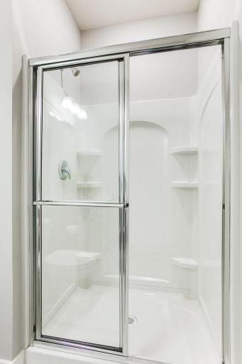 Main level bath with shower. *Photos of a similar home. Colors and options may vary.