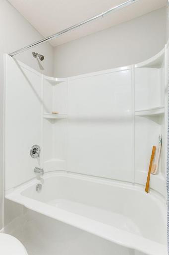 Hall bathroom with double vanity and built in linen closet. Separate bath/shower and toilet area. *Photos of a similar home. Colors and options may vary.