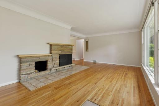 Living room with hardwood floors and a 2-sided fireplace