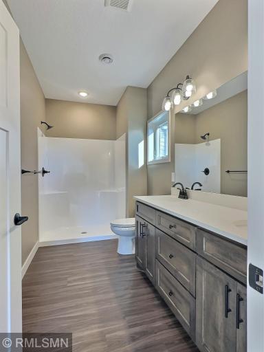 The walk in shower, double sinks and custom cabinets in the primary bedroom.