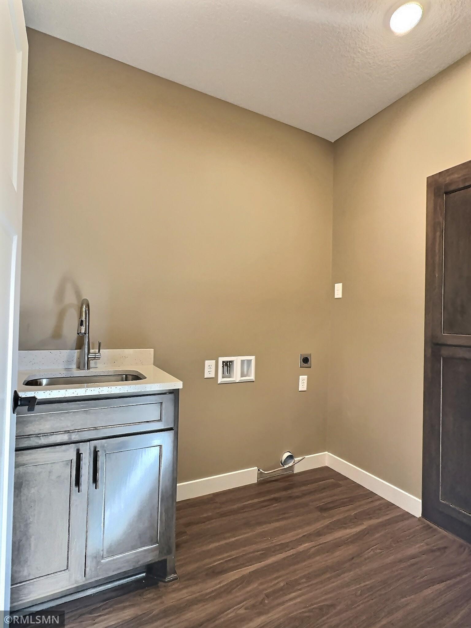 The laundry room is conveniently located outside the primary bedroom for ease of use.