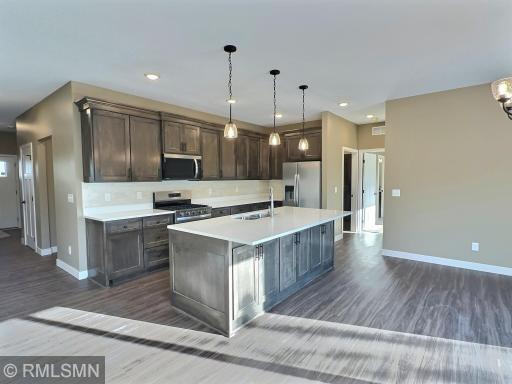 The open and flowing design of this area is ideal for patio home living. The kitchen, featuring a center island, seamlessly connects to the dining and living rooms.