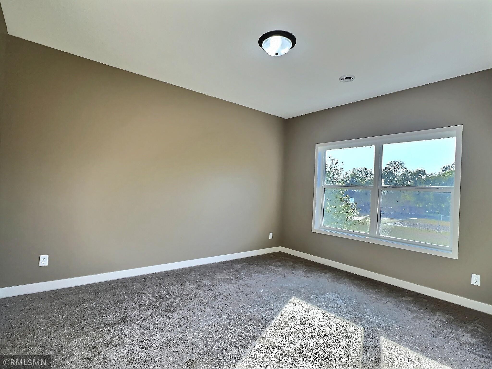 The primary bedroom offers private bath with walk in shower and walk in closet with the laundry room conveniently located right outside the door.