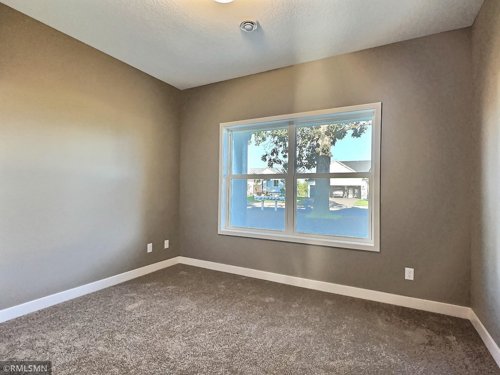 The first bedroom is located at the front of the home, overlooking the front porch and yard—making it an ideal space for a home office.
