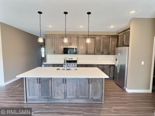 Open design to the kitchen with ample counter space on center island for your work station when prepping meals.
