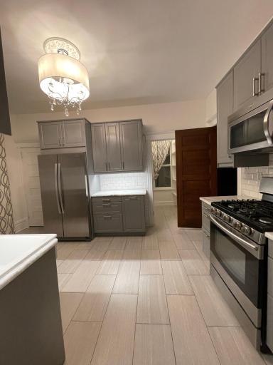 Walk-in pantry can be seen off of the kitchen.