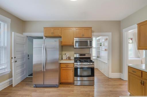 Main level kitchen with hardwood floors and stainless appliances.