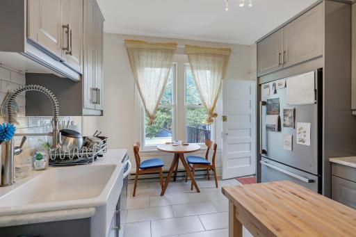 Stunning upstairs kitchen remodel with new cabinets, stone countertops, stainless appliances and tile floor