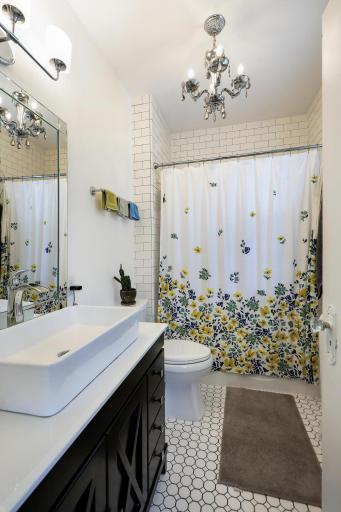 Updated upstairs bathroom feels clean and fresh with the modern finishes.