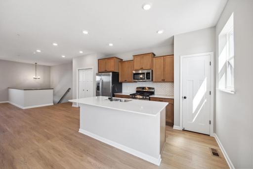 Kitchen -- However, ACTUAL island has been EXTENDED in this townhome! Seats up to 6!