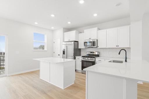 Kitchen with a center island and peninsula for plenty of counter seating. Picture for illustrative purposes.