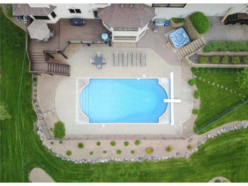Outdoor pool with impeccable landscaping.