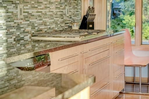 Gleaming stone countertops, 5 burner gas cooktop too!