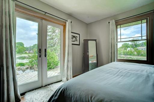 Primary bedroom with French doors to the deck.