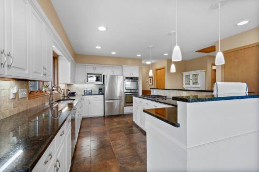 Tile Backsplash and Undercabinet Lighting accent the countertops, offering lots of workspace. Updated Sink, Faucet and Stainless Steel appliances, including Dual Ovens and Cooktop.