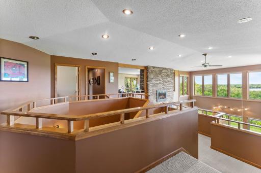 This home is exceptionally designed with distinct wings, centralized around a living room and staircase with soaring and vaulted ceilings.