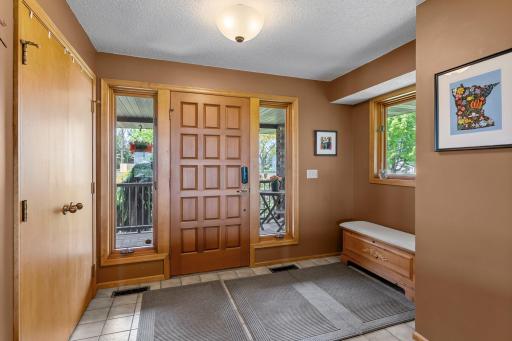 Spacious foyer with Dual Sidelight Windows, Tile Flooring and Coat Closet.