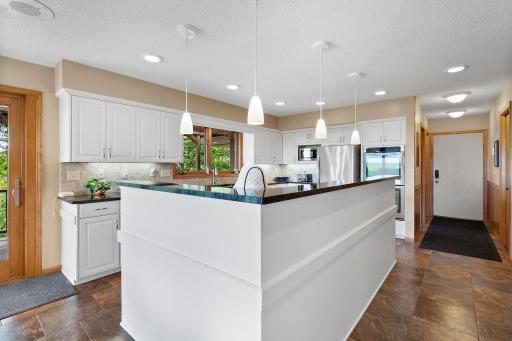 Easy access to the Main Level Laundry, Guest 1/2 Bath and the Attached, oversized Garage.