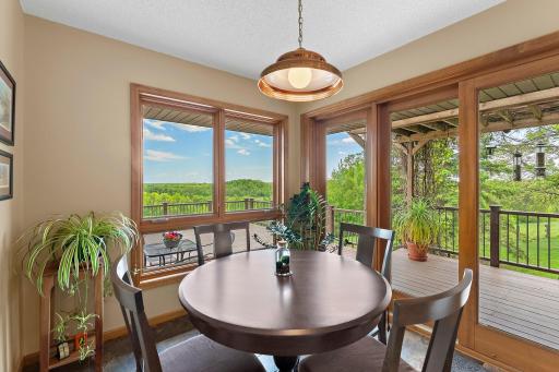 Corner windows in the dinette provide a view to the large deck, with sliding glass door access too.