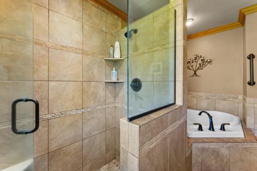 Luxury Shower with Custom Glass Doors and Tile Accents.