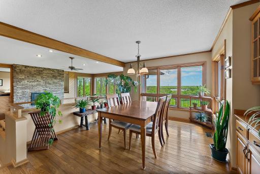 Dining room overlooks the great room and acreage beyond and offers Hardwood Flooring and Built-in Serving and Storage Buffett.