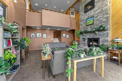This is a Happy Plant House! Note the Vaulted Ceilings on Upper Level and Detailed Wood Accent Wall.