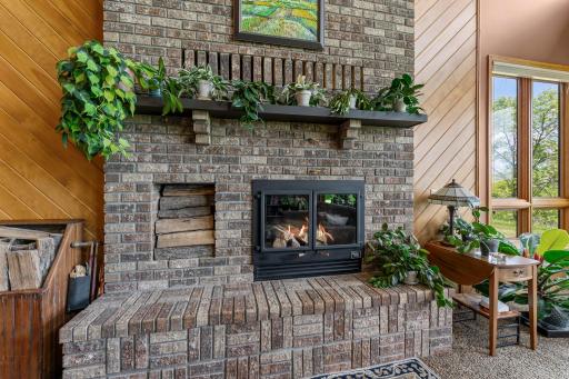 Classic Brick Fireplace with Raised Hearth, Mantle and Wood Box.