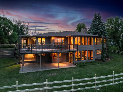 This Home sits prominently atop a bluff overlooking Forests, Fields, Lakeshore and miles of your own personal Walking Trails.