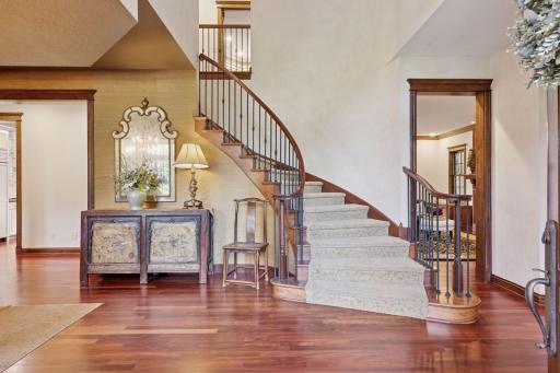 Step inside the dramatic entryway where Venetian plaster walls sweep along the staircase.