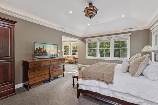 Relax in the large primary bedroom with tray ceiling and attached sitting room.