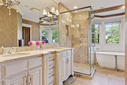The luxurious ensuite featuring heated floors and dual sinks.