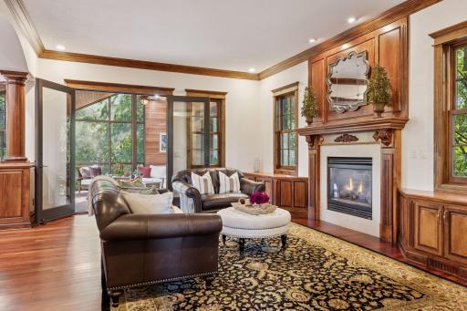 The living room with gas fireplace and custom millwork cabinets.