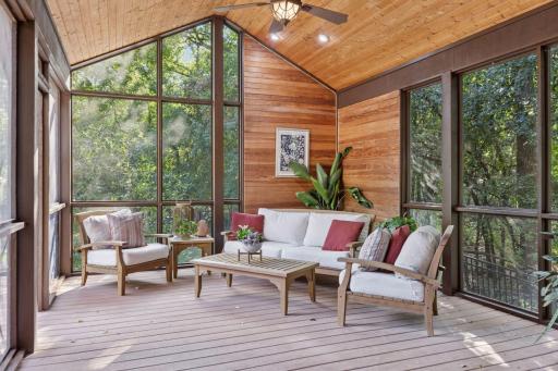 The main level summer screen porch flows seamlessly onto the expansive deck.
