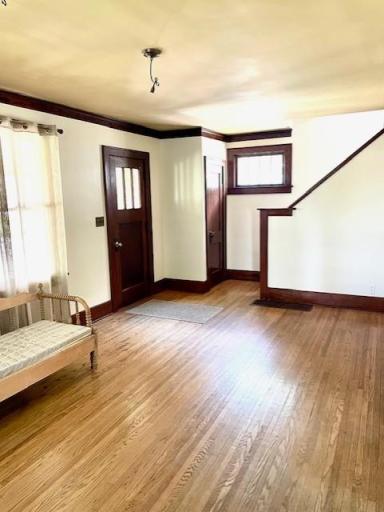 Living room with hardwood floors, cove ceilings and original woodwork