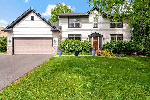 Home features new siding, roof and driveway with extra parking pad